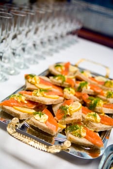 Salmon sandwiches with butter glasses on restaurant table