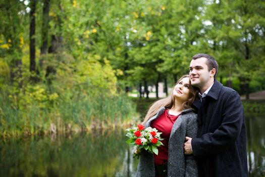 Two young lovers enjoying each other in park