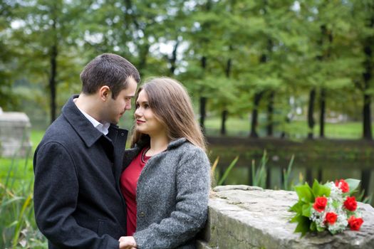 Two young lovers enjoying each other in park