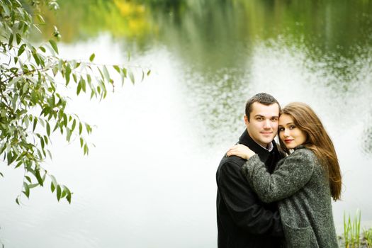 Two young lovers enjoying each other in park