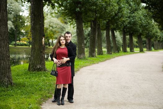 Two young lovers enjoying each other in park