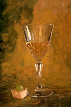 A glass of white wine on painted background