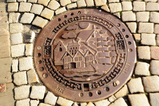 Manhole and  stone blocks in Bergen, Norway