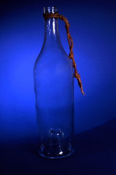 A empty old bottle isolated on blue background