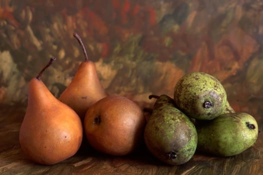 Yellow and green pears isolated on painted background