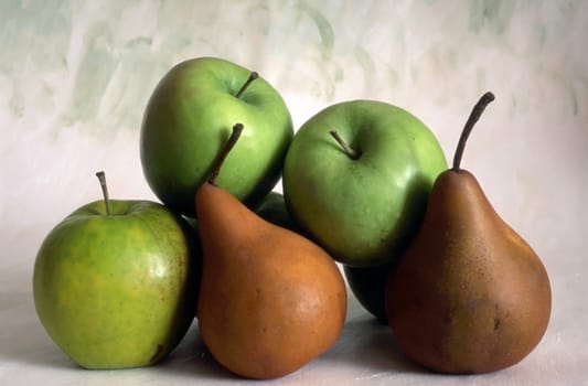 Apples and pears isolated on painted background