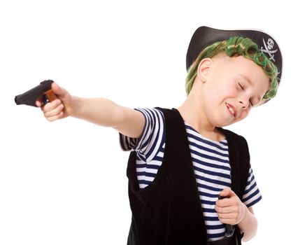 Boy wearing pirate costume shooting pistol isolated on white