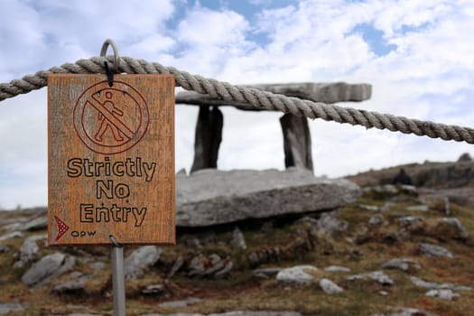 poulnabrone dolmen historic portal tomb in the burren in county clare with a no entry sign
