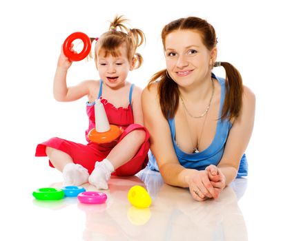 Mother playing with child holding pyramid isolated on white