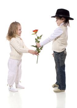 boy giving rose for his little girlfriend isolated on white