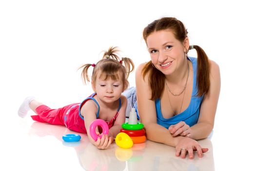 Mother playing with child holding pyramid isolated on white