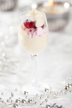 Delicious dessert with meringue, raspberries and cream