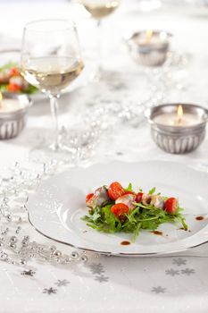 Festive christmas table with appetizer on plate