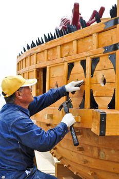 Yeosu, Korea - May 05: A traditional Korean craftsman working on a cultural turtle ship for the annual festival.  Yeosu will hold the 2012 World Expo.