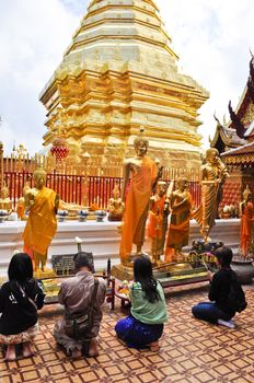 Chiang Mai, Thailand - December 22:  People praying at a famous buddhist temple in Thailand on December 22, 2010