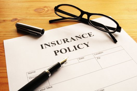 insurance policy form on desk in office showing risk concept