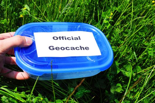 geocaching concept with blue geocache box showing outdoor sports concept