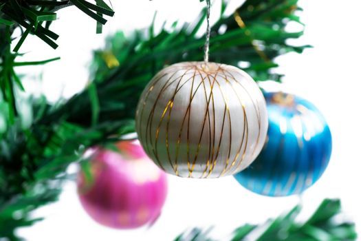 Christmas decorations on a brach of manufactured christmas tree