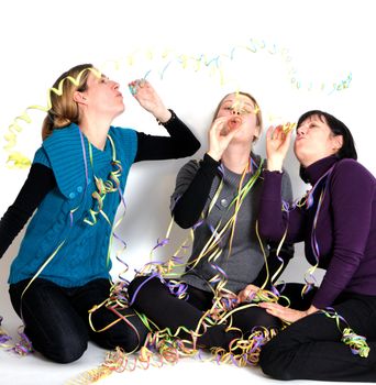 Two young women and one senior woman laughing at party.