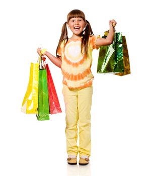 Smiling six years Girl holding presents bags isolated