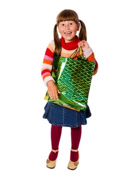 Smiling six years Girl holding presents bags isolated