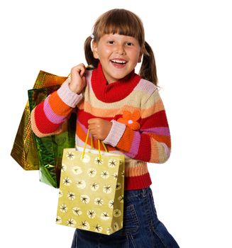 Smiling six years Girl holding presents bags isolated