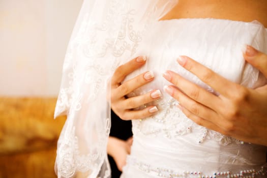 Bride dressing up holding top 