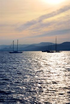 Anchored sailboats at sunset at Mediterranean coast