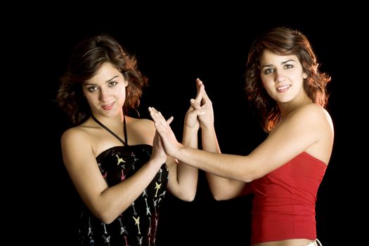 Two young beautiful sisters giving the hands and having fun - This models are true twins