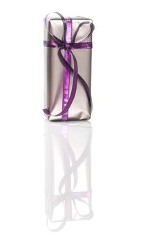 Silver Gift with violet straps on white with relflection