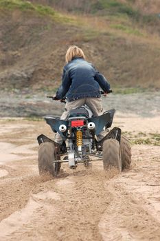 young boy in action with ATV