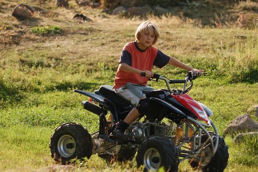 young boy riding ATV for fun