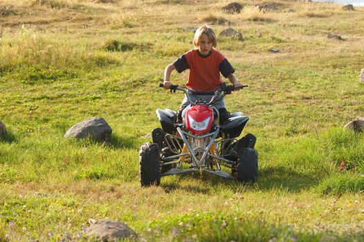 young boy riding ATV for fun