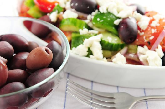 Black kalamata olives and greek salad with feta cheese