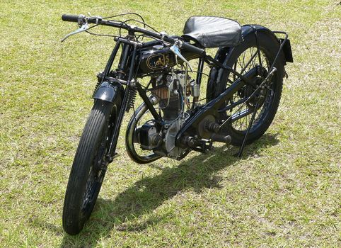 Vintage motorcycle parked on grassy lawn