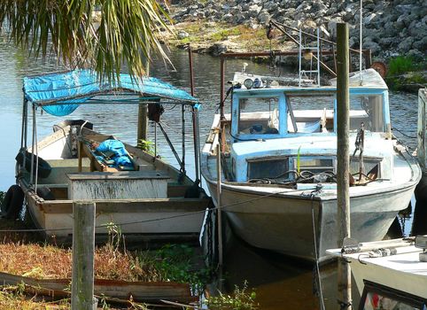 Broken down boats docked at shore