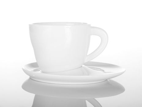 Empty cup of tea on white with reflection