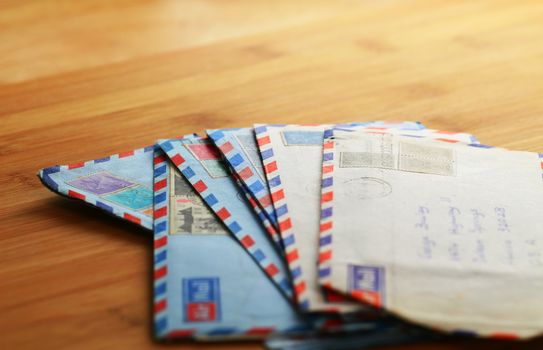 Airmail letters spread on table top.