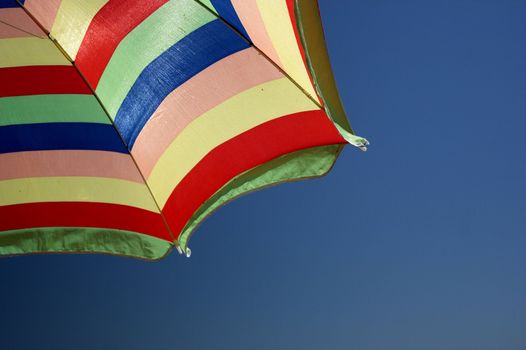 beach umbrella and deep blue sky