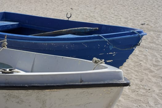 Two fishing boats standing on the sand of a beach