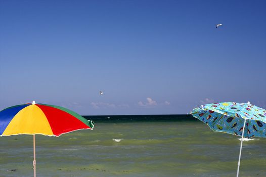 Two color umbrellas in the beach