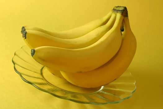 Bananas, yellow background.
