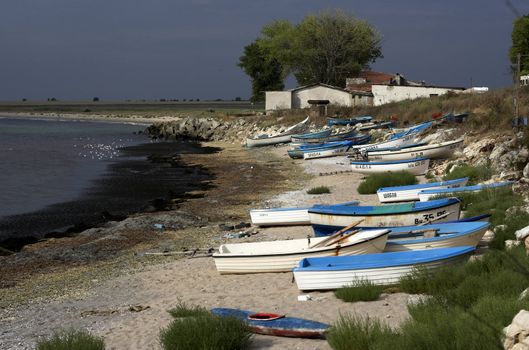  fishing boats  standing on the sand of a beach