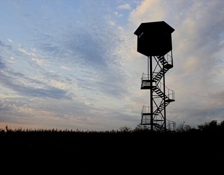  silhouette of a tower over the sky