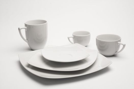 White plates and cups over the white