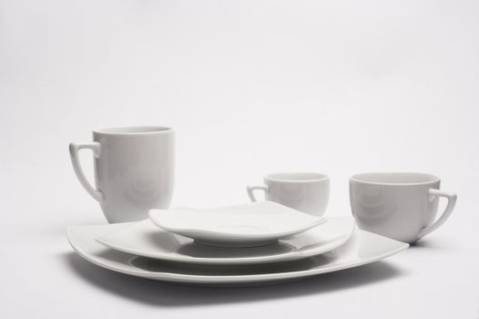 White plates and cups over the white