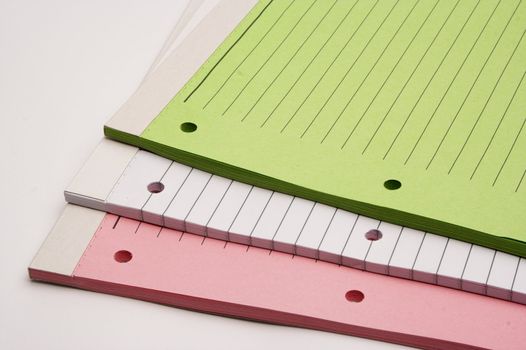 Colored blank notebooks over white