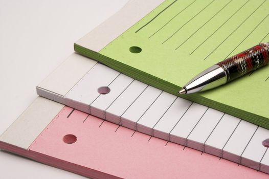 Colored blank notebooks over white