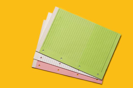 Colored blank notebooks over yellow