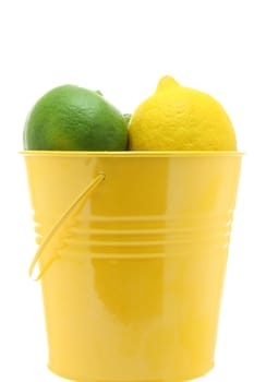 A yellow bucket of citrus fruit